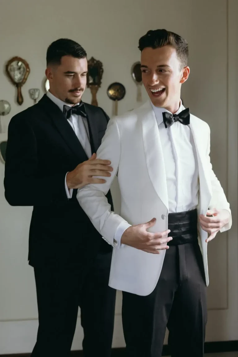 Male client wearing white tuxedo jacket with black bow tie
