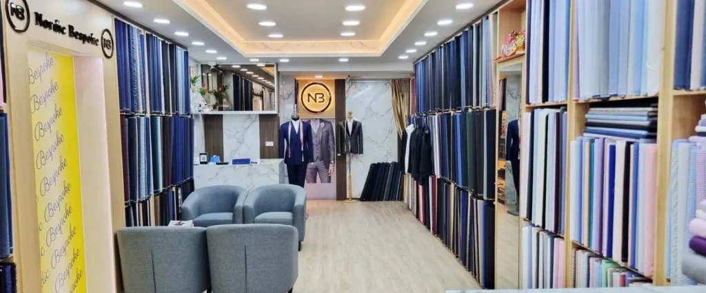 Interior of Nordic Bespoke Tailor showroom with fabric displays and seating area