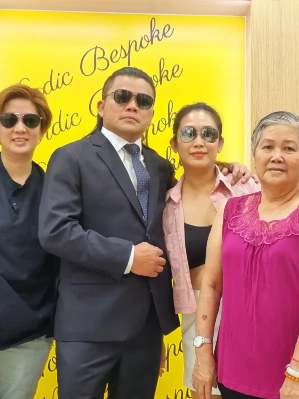 Happy customers posing inside Nordic Bespoke Tailor showroom