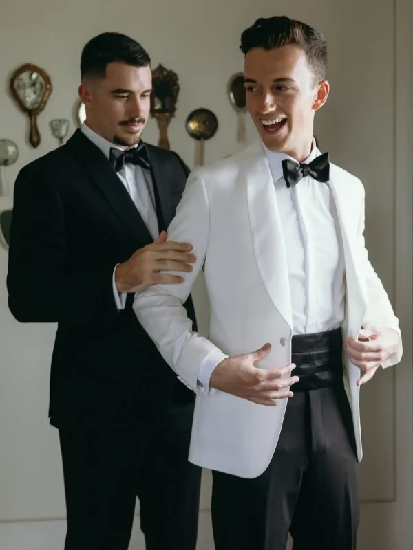 Male client wearing white tuxedo jacket with black bow tie
